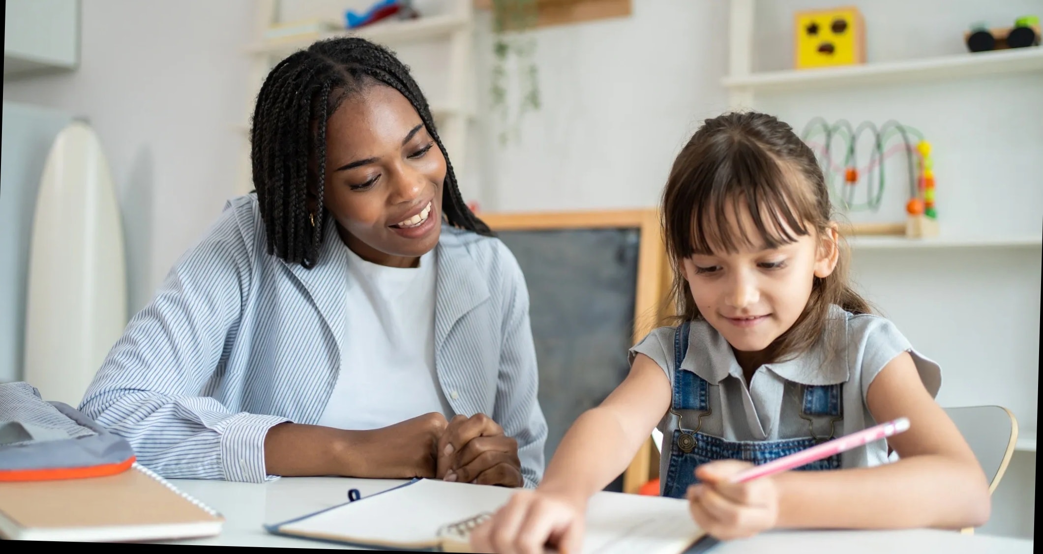 Student receiving homework help from a tutor after school